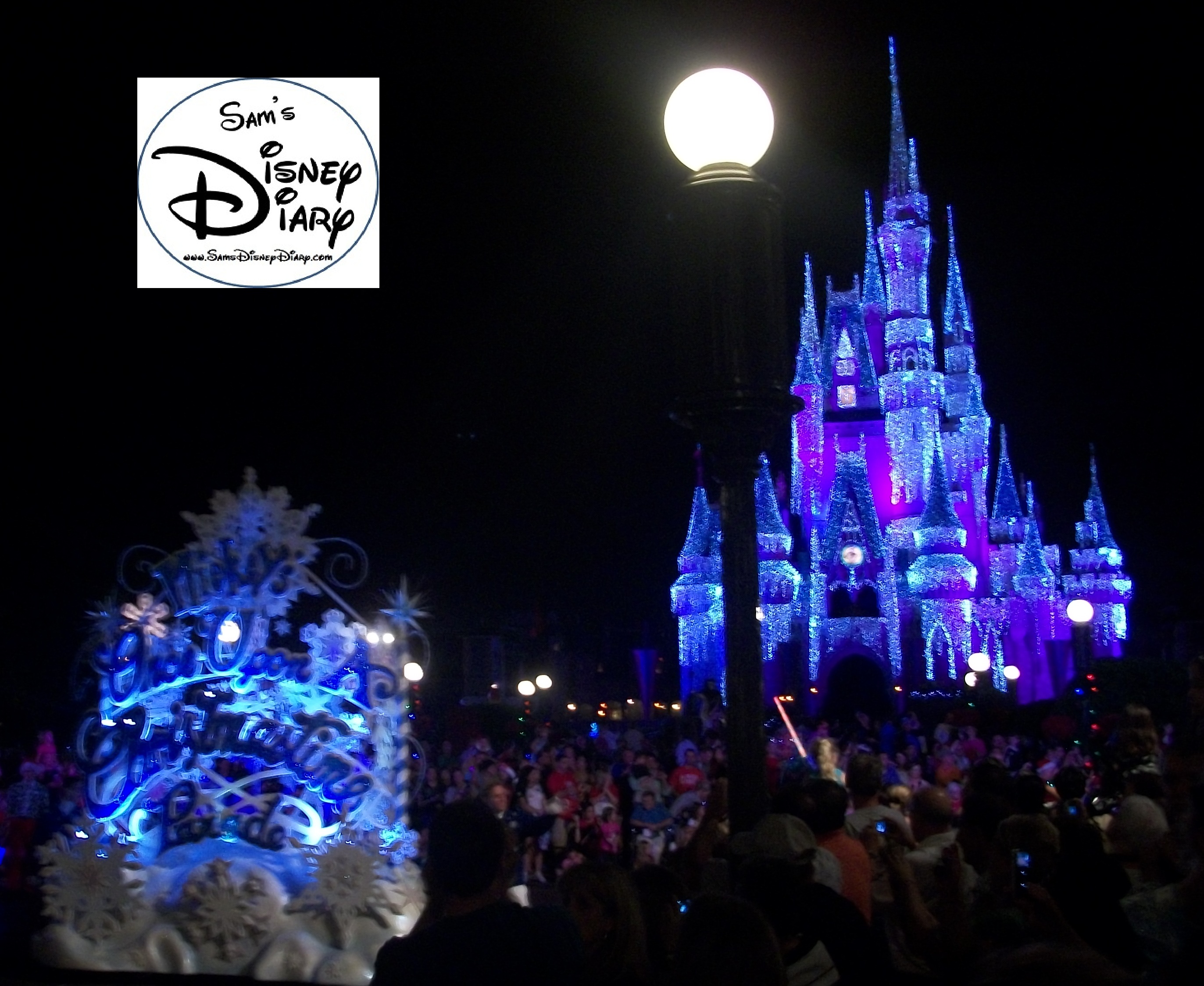 Mickey’s Once Upon a Christmastime parade passes by the Holiday Lights on Cinderella’s Castle. 