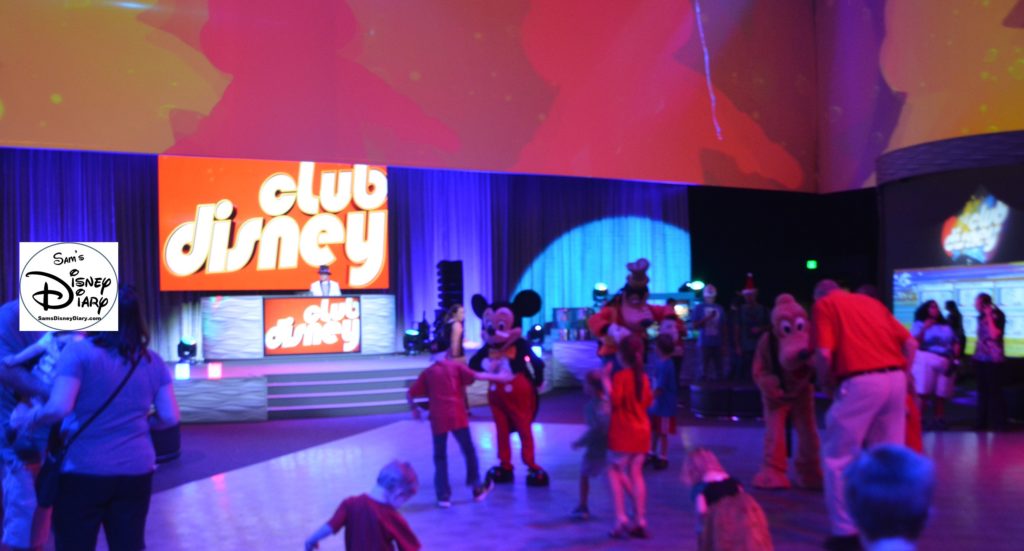 Mickey and other characters dance with guests at Club Disney