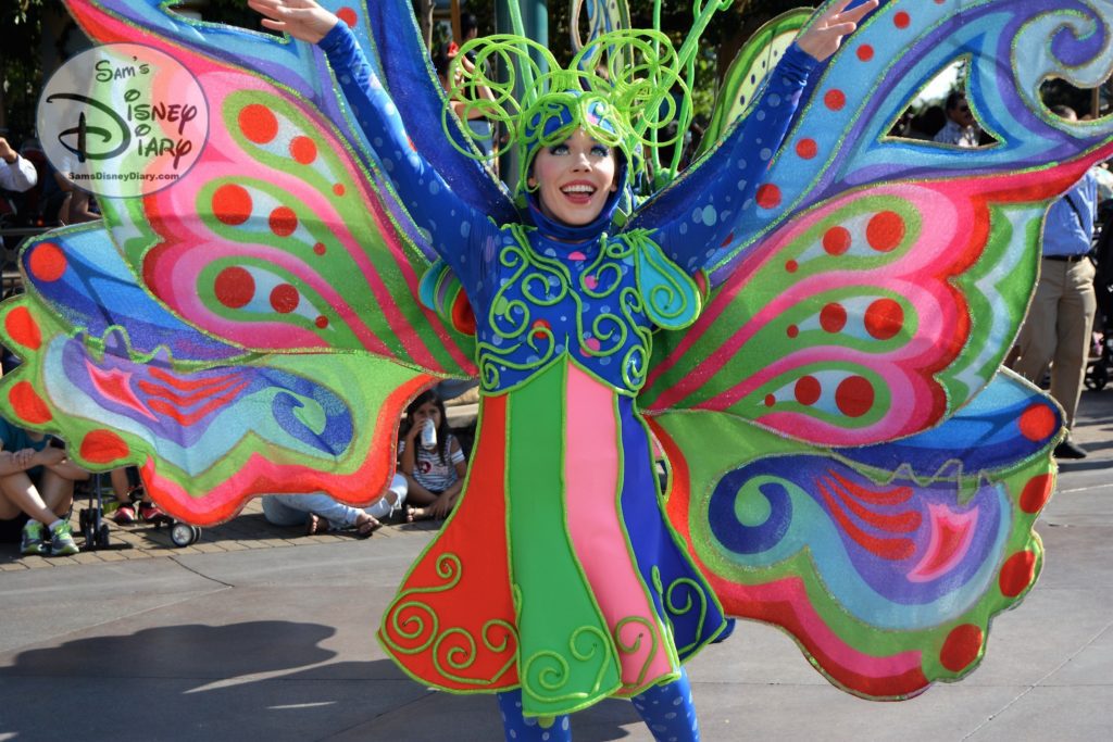 Tinker Bell followed by colorful costumes during Mickey's Soundsatonal parade.