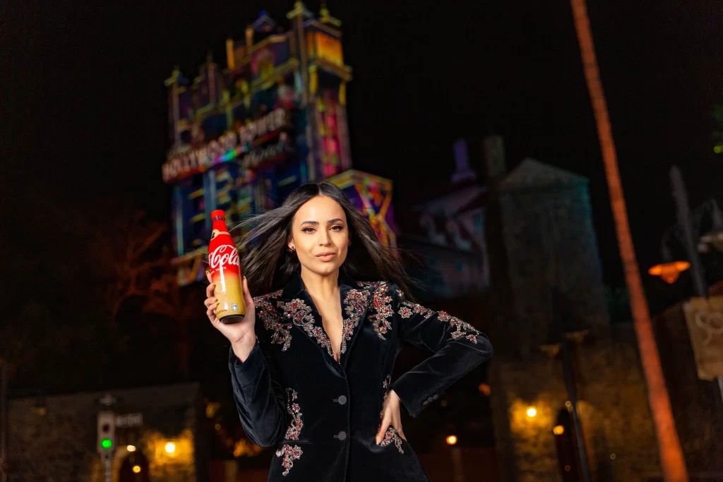 To celebrate the 50-year collaboration between Walt Disney World Resort and Coca-Cola, Sofia Carson helped unveil five unique co-branded collectible bottles that are now available exclusively at the resort during the 50th Anniversary Celebration. Sold at locations throughout each of the four Walt Disney World theme parks, there are four different bottles featuring each of the 4 park icons with their own unique EARisdescent color on the labels, plus a fifth bottle with a special gold label. The bottles are shaped just like the bottles that were sold at Walt Disney World when it opened in 1971