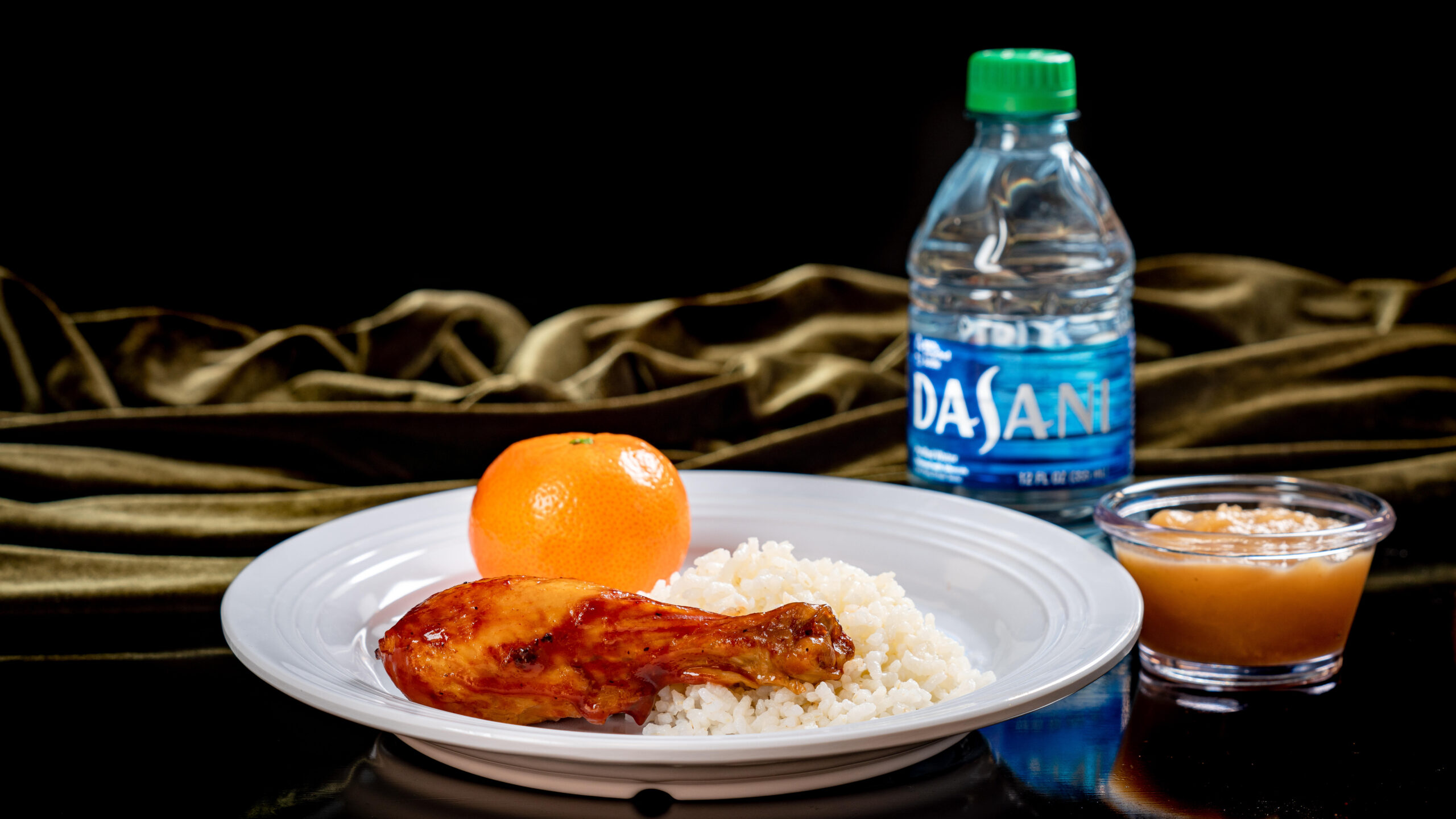Roasted Chicken Drumstick (Tiana’s Palace at Disneyland Park in Anaheim, Calif.) – with sweet BBQ sauce and heirloom rice served with a Cuties® Mandarin orange and applesauce with choice of DASANI® water or small lowfat milk. Available beginning Sept. 7, 2023. For more details, visit DisneyParksBlog.com. (David Nguyen/Disneyland Resort)
