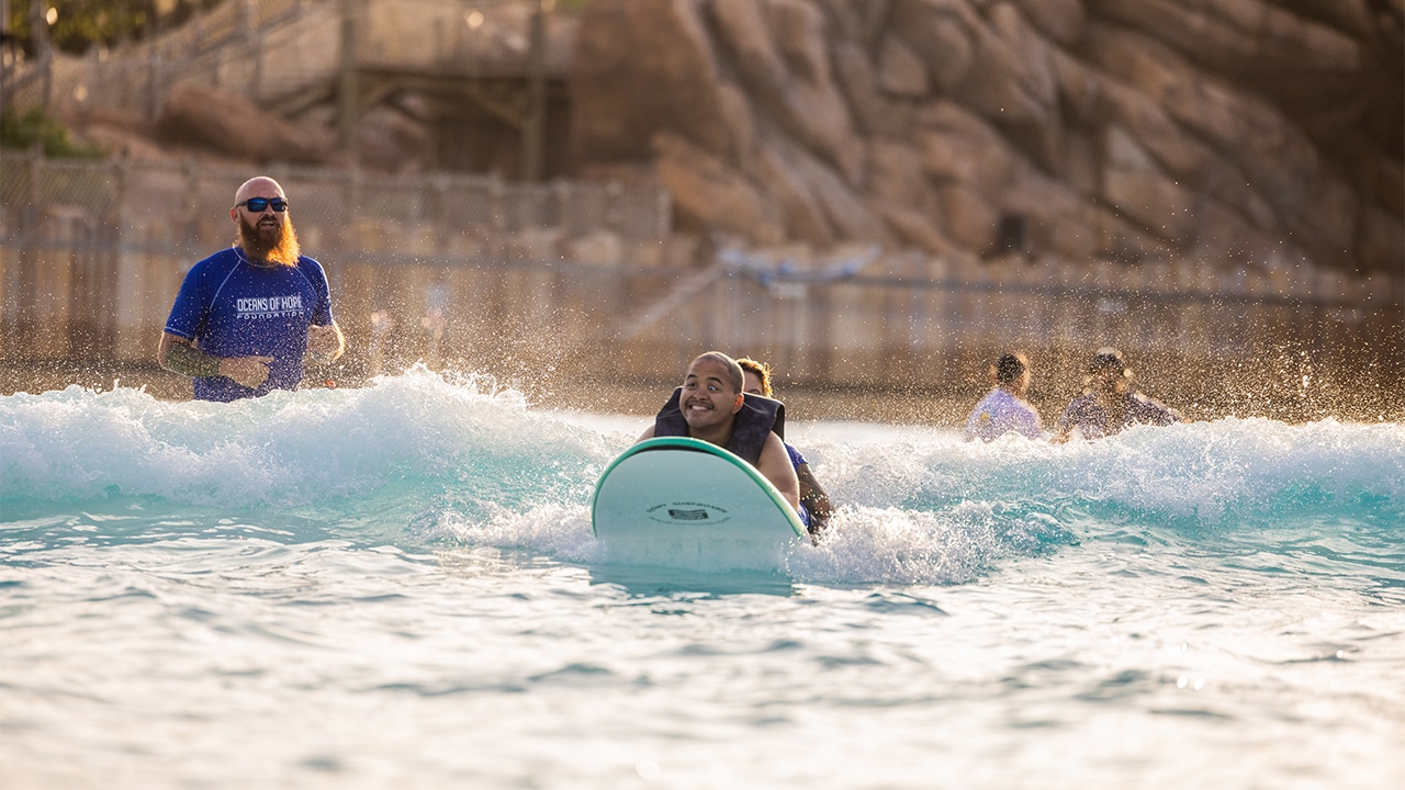 A young man surfing in the Typhoon Lagoon Surf Pool