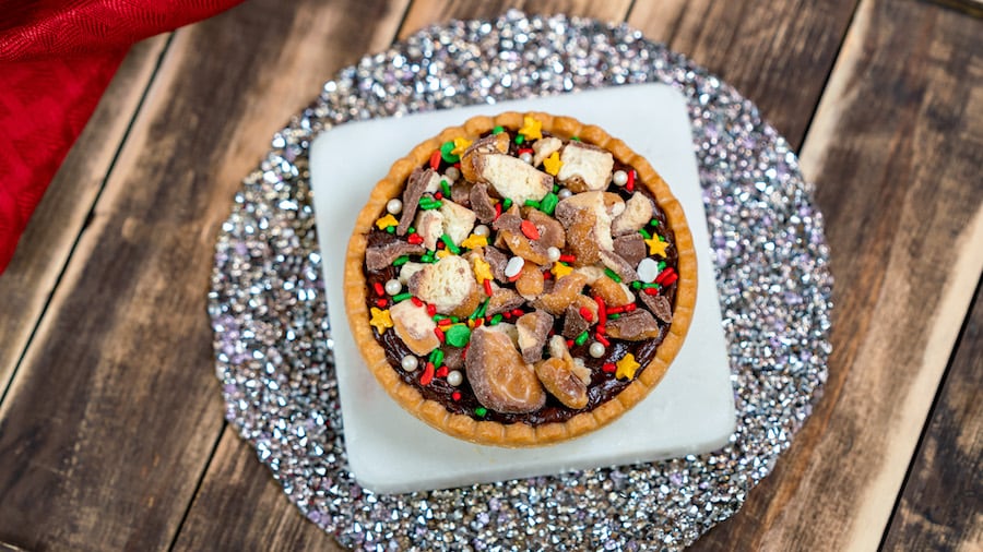 Chocolate Tart Made with TWIX Cookie Bar Pieces: Sugar tart filled with caramel and chocolate mousse, topped with TWIX cookie bar pieces and holiday sprinkles (New) at Disneyland Resort
