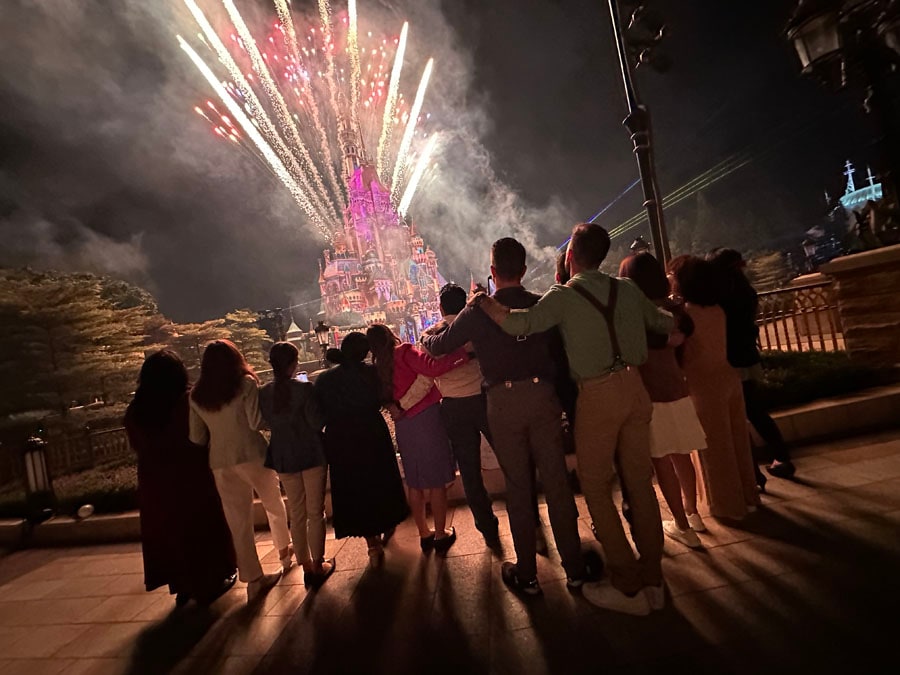 The Disney Ambassadors watch as fireworks illuminate the Castle of Magical Dreams during the "Momentous" nighttime spectacular