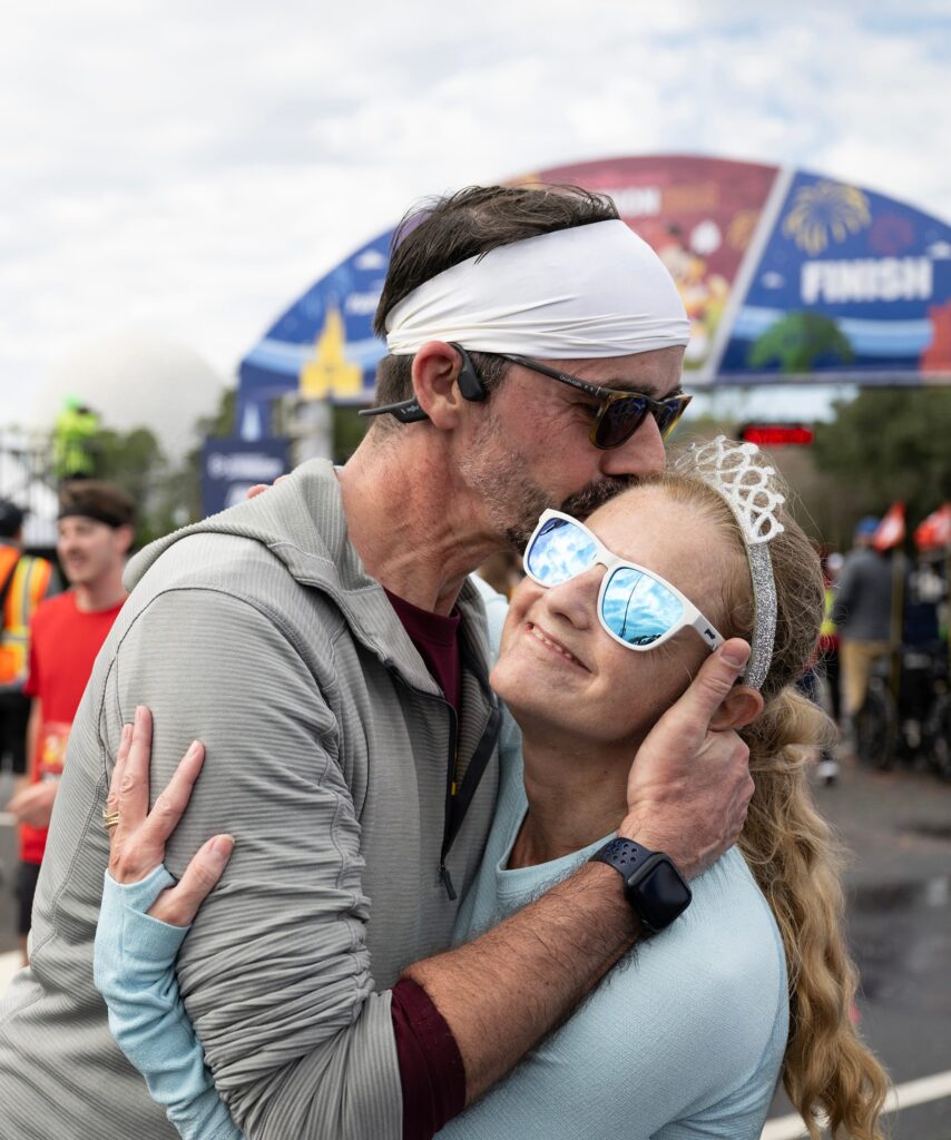 Charlotte area runner Susan Moriceau, who is blind, celebrates with her husband after completing the Walt Disney World Marathon on Sunday. The pair, who run tethered together, also ran the 5K, 10K and weather-shortened half marathon earlier in the weekend to complete the “Dopey Challenge’’ at Walt Disney World Resort in Lake Buena Vista, Fla. (Mark Ashman, photographer)