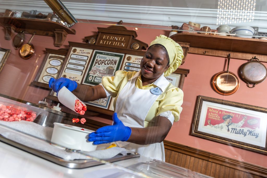 Disney culinary cast member prepares popcorn for guests