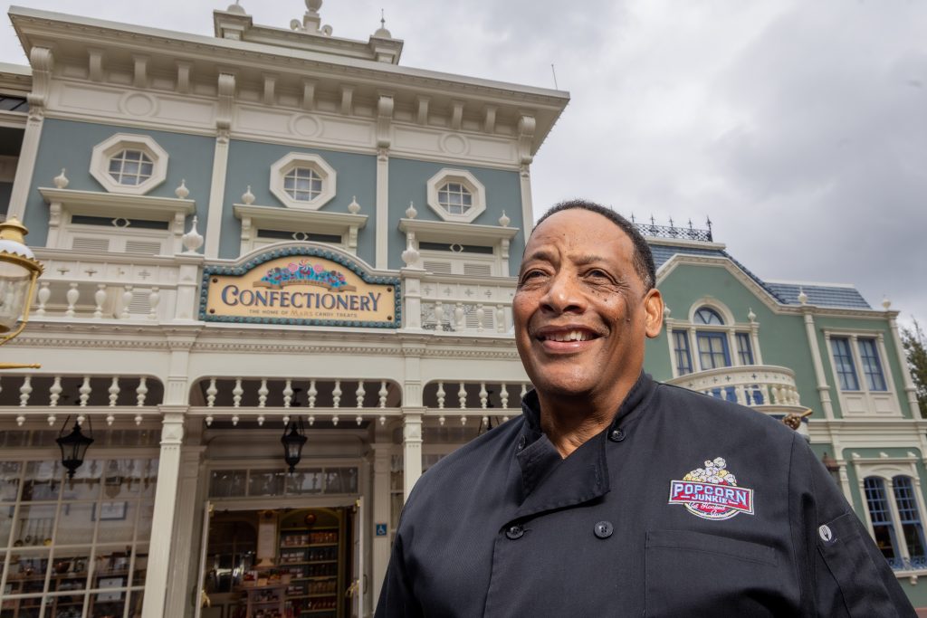 Neal Crosier, co-founder of Popcorn Junkie smiles on Main Street