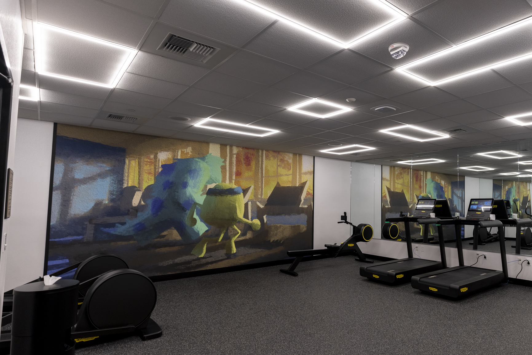 Hotel guests can enjoy a new and expanded fitness center featuring a mural of Mike and Sulley from “Monster’s University” running on a treadmill, inspired by Pixar’s “Monsters University.” (Christian Thompson/Disneyland Resort)