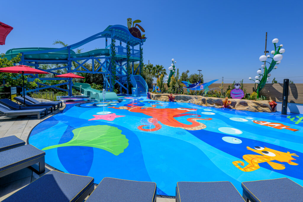 Hotel guests can enjoy a colorful water play area where families can splish and splash at Pixel Pool, take a winding water ride down Crush’s Surfin’ Slide and frolic with Hank on the pop-jet splash pad at Nemo’s Cove at Pixar Place Hotel at Disneyland Resort in Anaheim, Calif. (Richard Harbaugh/Disneyland Resort)