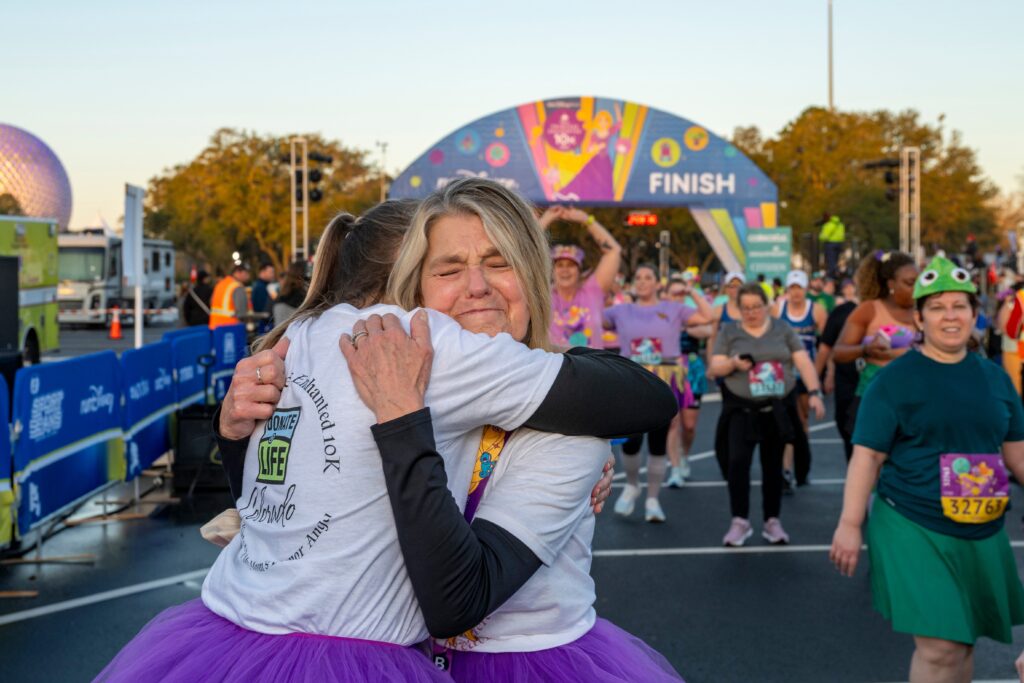 Kim Schaefer, 67, from Colorado, hugs her daughter at the finish line of the Disney Princess 10K presented by CORKCICLE at Walt Disney World Resort in Lake Buena Vista, Fla. on Saturday, Feb. 24. The runDisney event was the first race for Schaeffer who underwent double lung transplant surgery in 2020 after she was diagnosed with interstitial lung disease. (Omark Reyes, photographer)