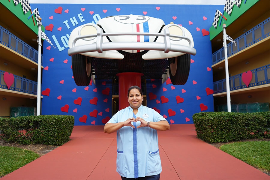 Cast member in front of Herbie The Love Bug at Disney's All-Star Movies Resort