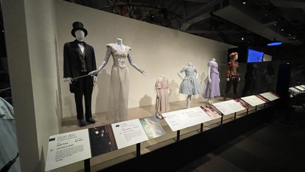 Disney Archives Disney Heroes & Villains: The Art of the Disney Costume 'Cinderella's Workshop Disney Costumes include Oscar Diggs, Glinda, Dorthy Gale