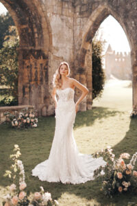 Echoing Princess Aurora's cloaked and corseted aesthetic, the Aurora Platinum look is a customizable floral lace bridal gown with a detachable statement cape, designed in a matching flowered lace. Remove the cape to reveal a sheath gown with a traditional strapless sweetheart neckline!