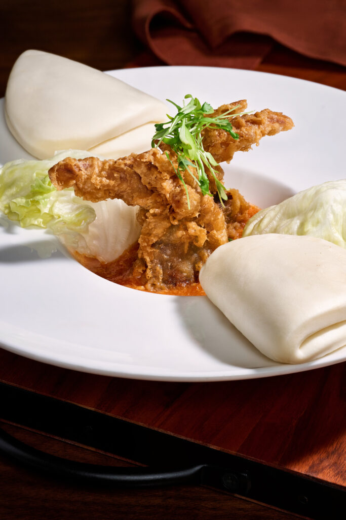 •Crispy Soft Shell Crab with Singaporean-style spicy chili sauce and bao buns. An arrangement of Singaporean cuisine