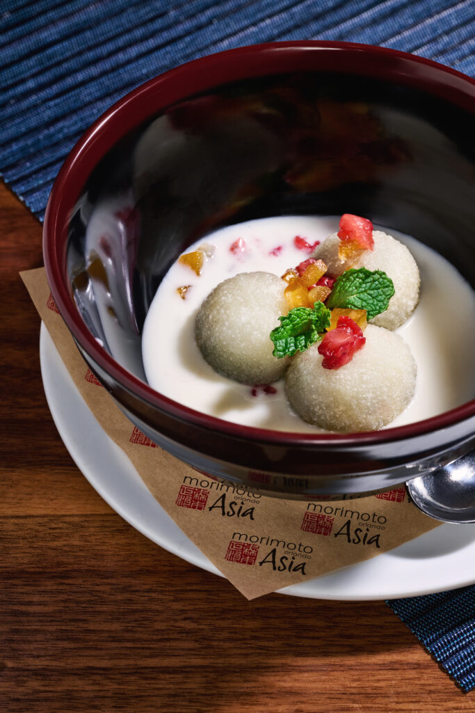 “Tang Yuan” black sesame paste filled mochi, with warm coconut broth, orange zest, and strawberries. A traditional Chinese dessert