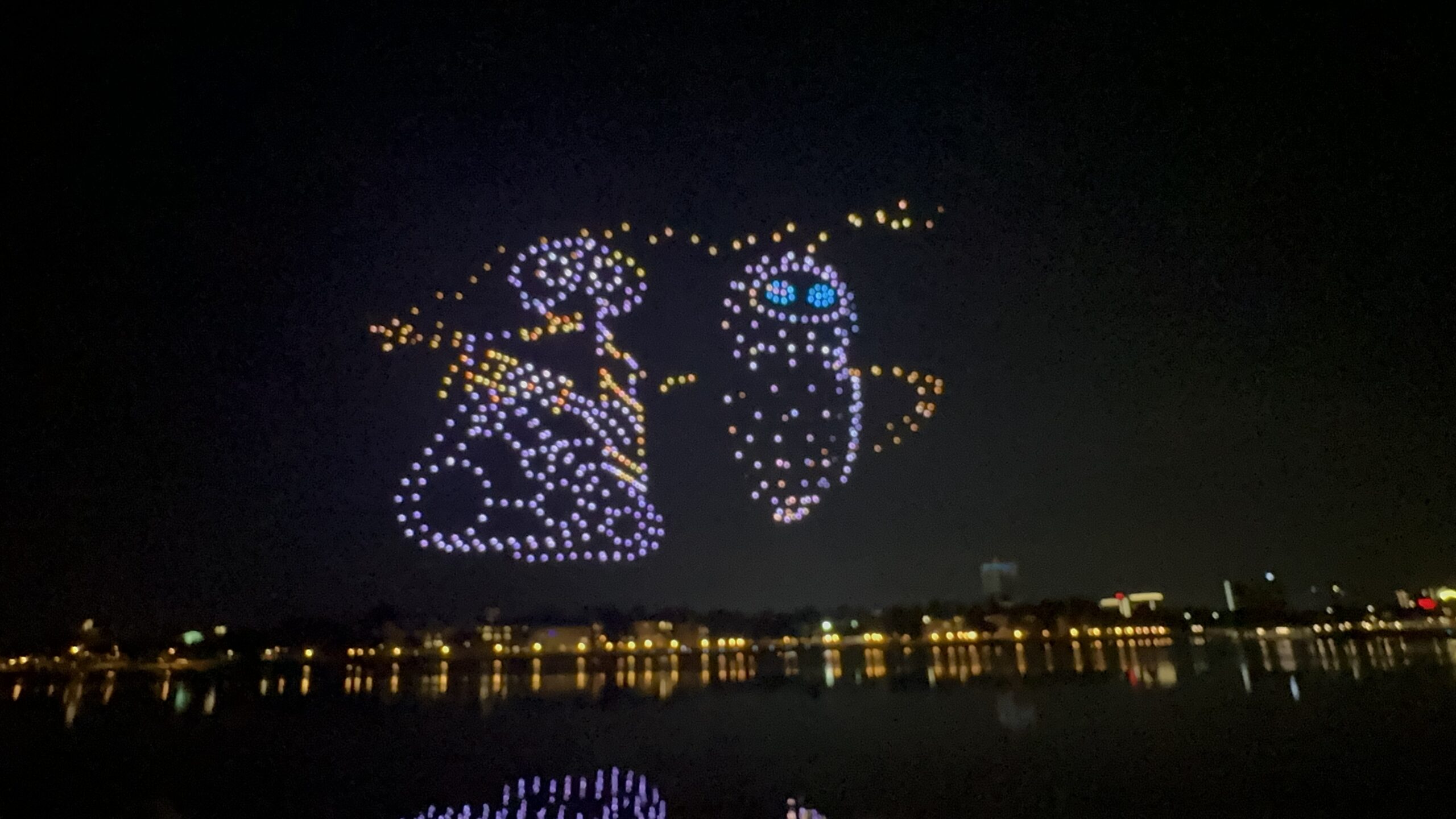 Drones magically form various Disney characters in the sky, including Wall-E &; Eve from Pixar’s “Wall-E,”