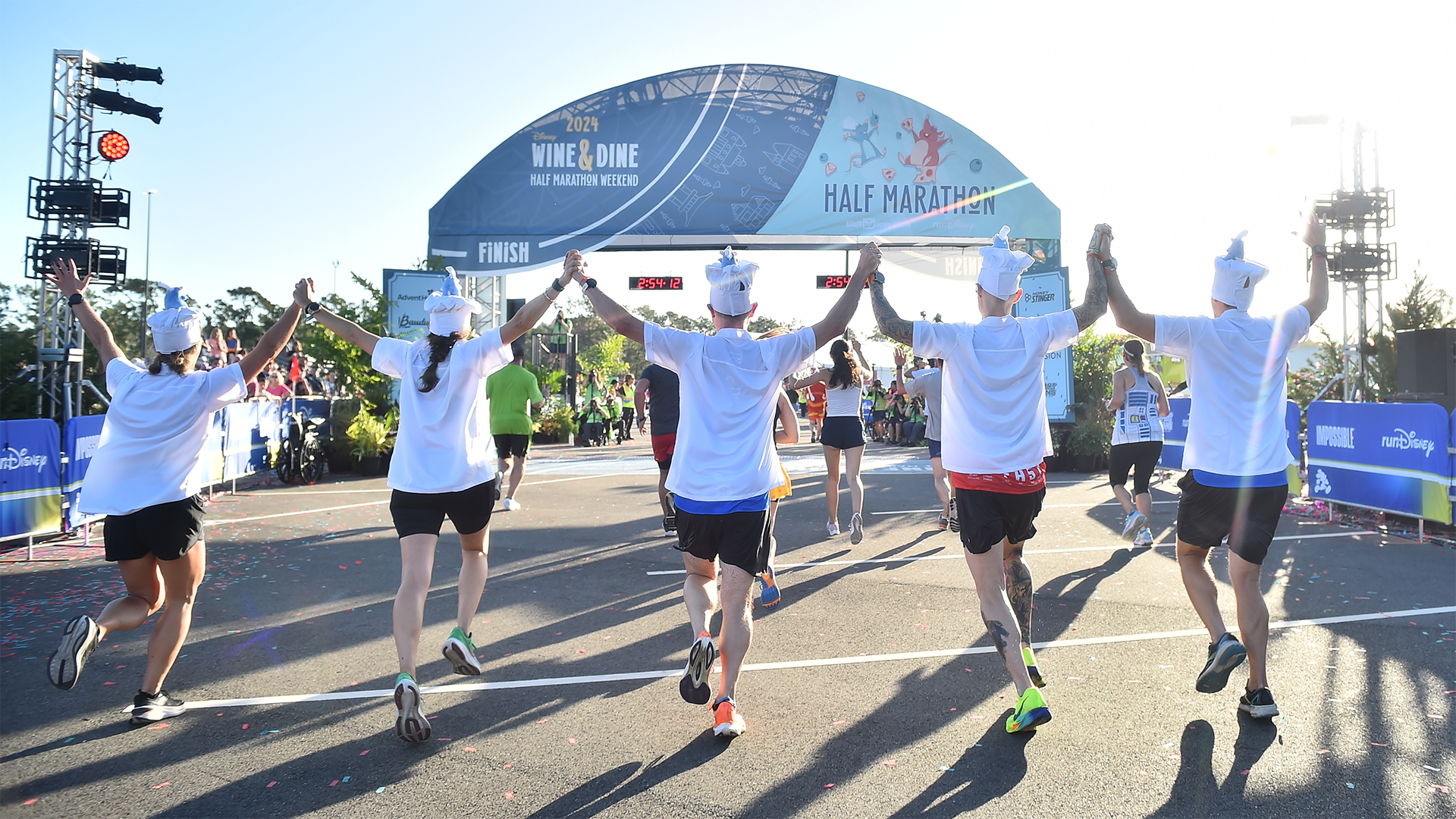 Runners in chef costumes participate in the 2024 Disney Wine & Dine Half Marathon Weekend