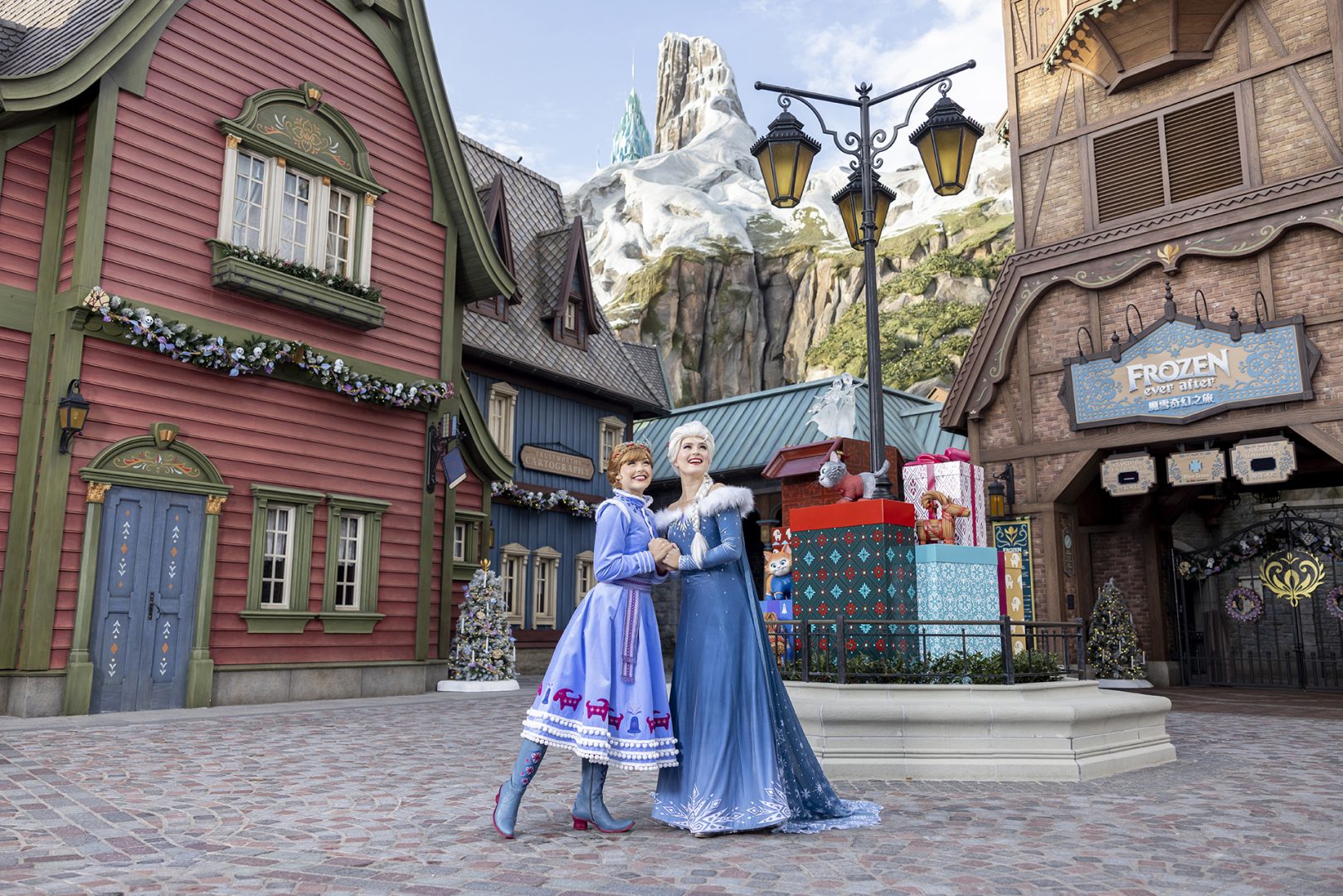 Anna and Elsa in holiday attire at World of Frozen