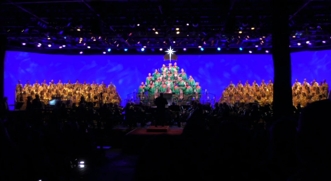 Jodi Benson lights up the stage as she narrates the story of Christmas during the final 2024 Candlelight Processional at EPCOT’s Festival of the Holidays