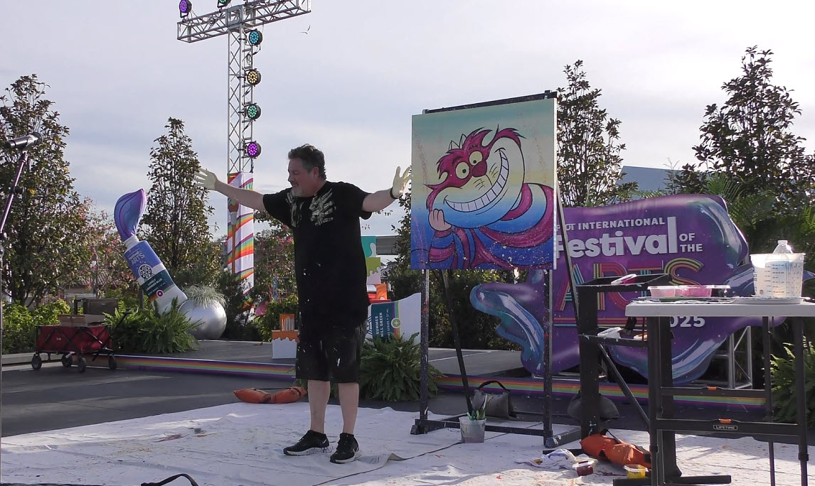 Trevor Carlton brings the whimsical Cheshire Cat to life during his live painting performance at the 2025 EPCOT Festival of the Arts in CommuniCore Plaza.