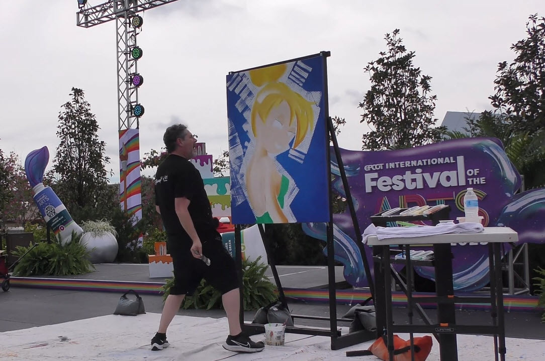 Trevor Carlton brings 'Sassy Tink' to life with bold colors and high-energy artistry during his live performance at the 2025 EPCOT Festival of the Arts in CommuniCore Plaza